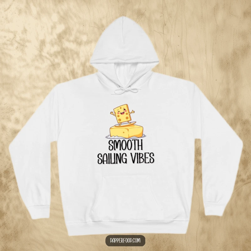 Funny delighted cheese slice character surfing on a giant pat of butter with a goofy grin, on a cozy funny hoodie.